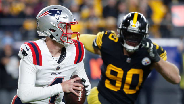 New England Patriots quarterback Bailey Zappe (4) runs the ball as Pittsburgh Steelers linebacker T.J. Watt (90) chases during the third quarter at Acrisure Stadium. New England won 21-18.